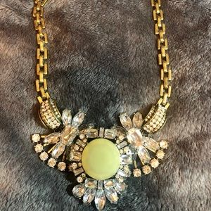 Silver necklace with yellow stone.